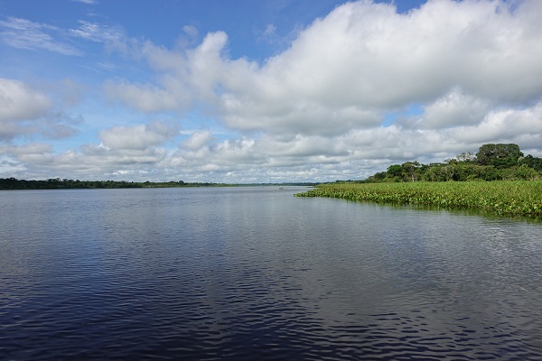 Lago Imiria: a large, calm lake under a partly cloudy sky